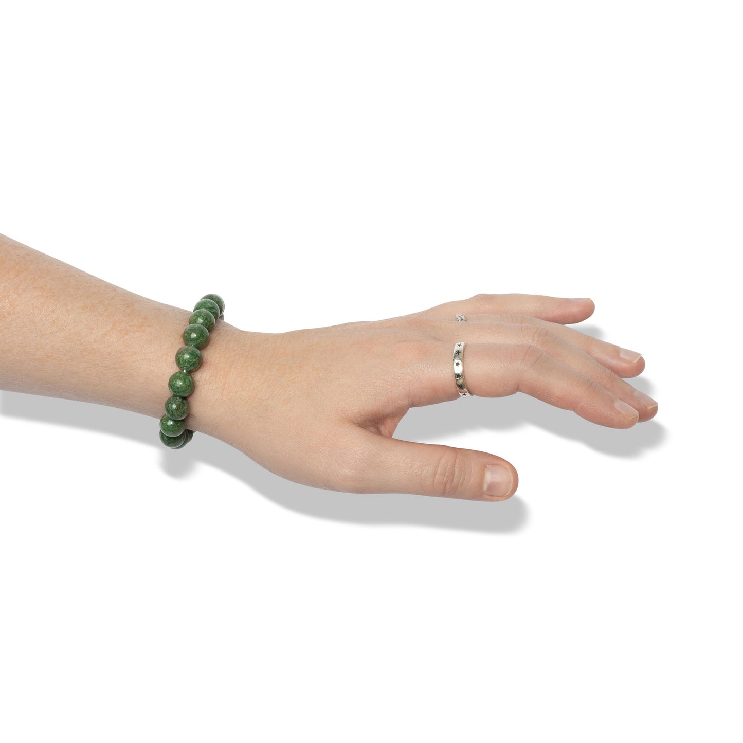 A single crystal gemstone bracelet made of African jasper, positioned on a hand adorned with two silver rings.