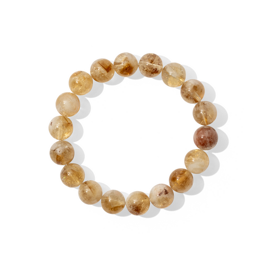 A single crystal gemstone bracelet made of citrine. A semi-transparent, shiny bright yellow with slightly milky inclusions.