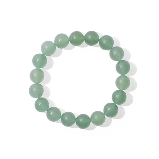 A single crystal gemstone bracelet made of green aventurine quartz. A semi opaque, shiny, mid-toned fresh green.