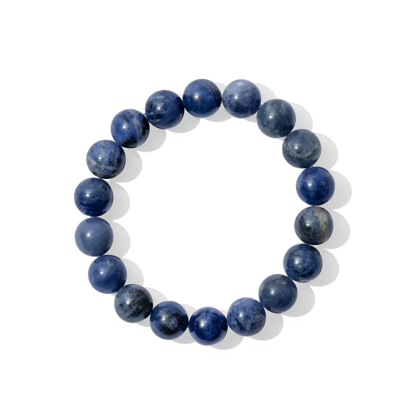A single crystal gemstone bracelet made of sodalite. An opaque, shiny, rich, dark blue.