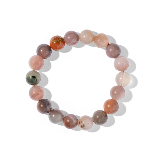A single crystal gemstone bracelet made of Yanyuan candy agate. A semi-opaque, shiny mixture of pink, white, plum, and green.