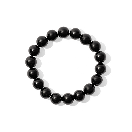 A single crystal gemstone bracelet made of black tourmaline. A fully opaque, shiny solid black.