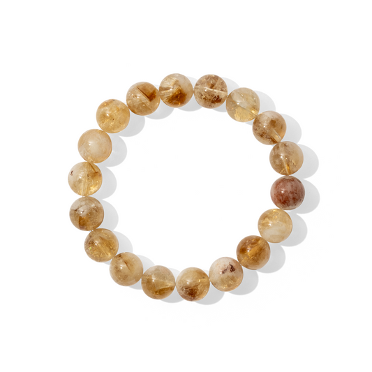A single crystal gemstone bracelet made of citrine. A semi-transparent, shiny bright yellow with slightly milky inclusions. 