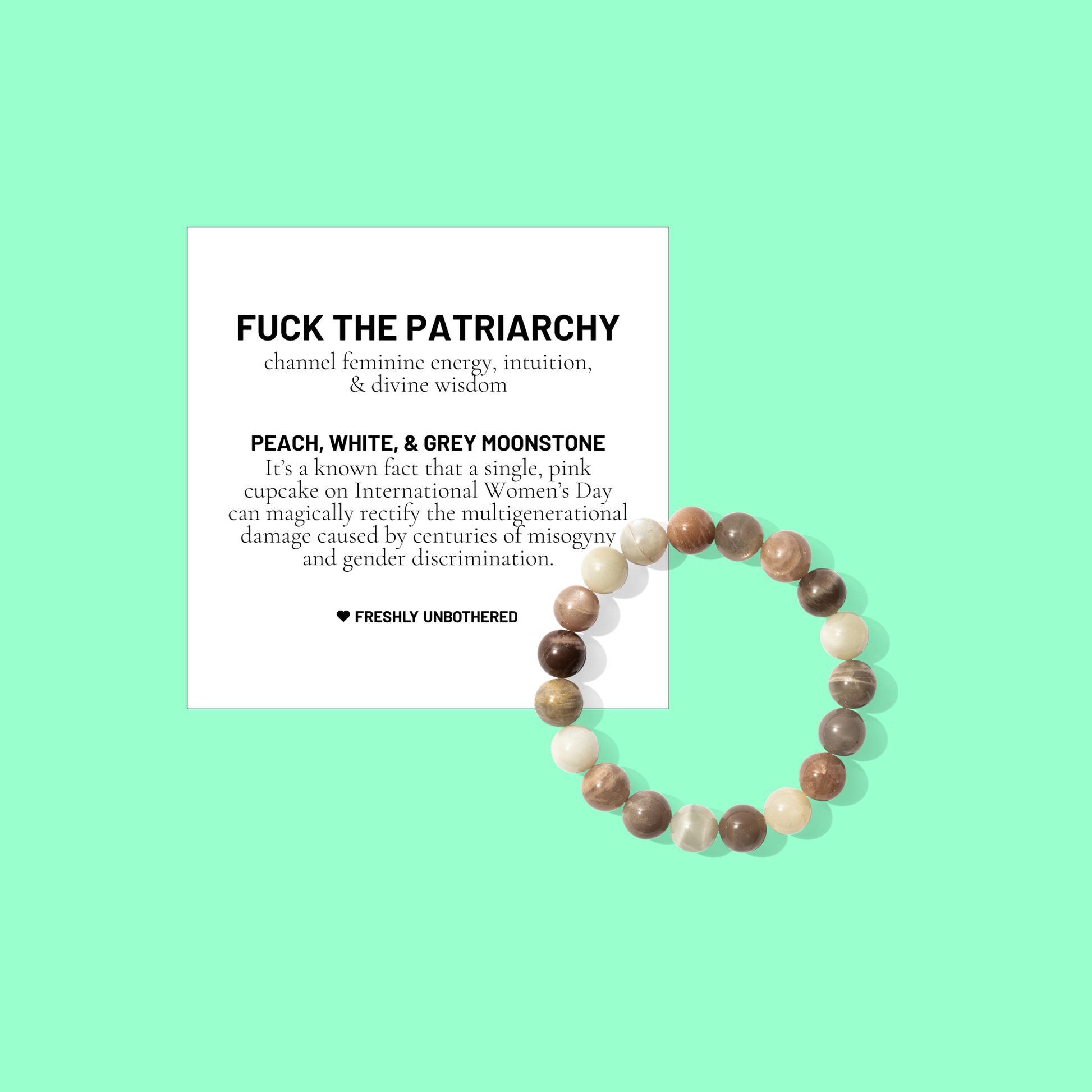 A green coloured background with a white card bearing the description of a crystal gemstone bracelet, and a round peach, white, and grey moonstone bead bracelet, positioned below and to the right of the card.