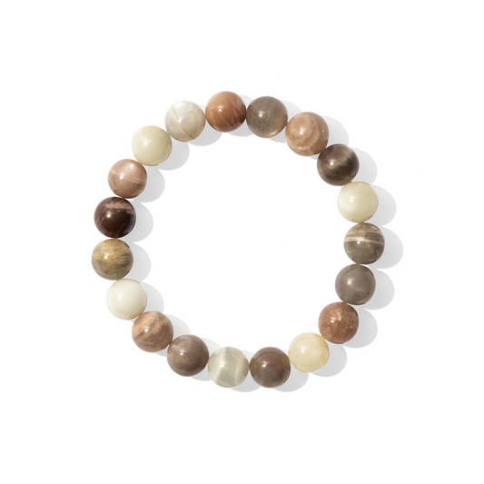 A single crystal gemstone bracelet made of peach, white, and grey moonstone. An opaque, shiny mixture of milky, peach, and light grey tones with subtle flash.
