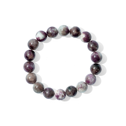 A single crystal gemstone bracelet made of plum blossom tourmaline. A fully opaque, shiny plum purple swirled with white and grey marbling.