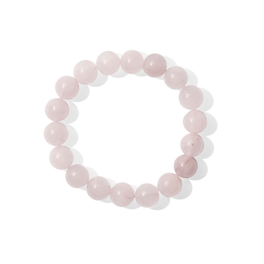 A single crystal gemstone bracelet made of rose quartz. A semi opaque, shiny delicate light pink.