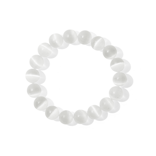 A single crystal gemstone bracelet made of selenite. A semi-opaque, shiny, white with high intensity flash.