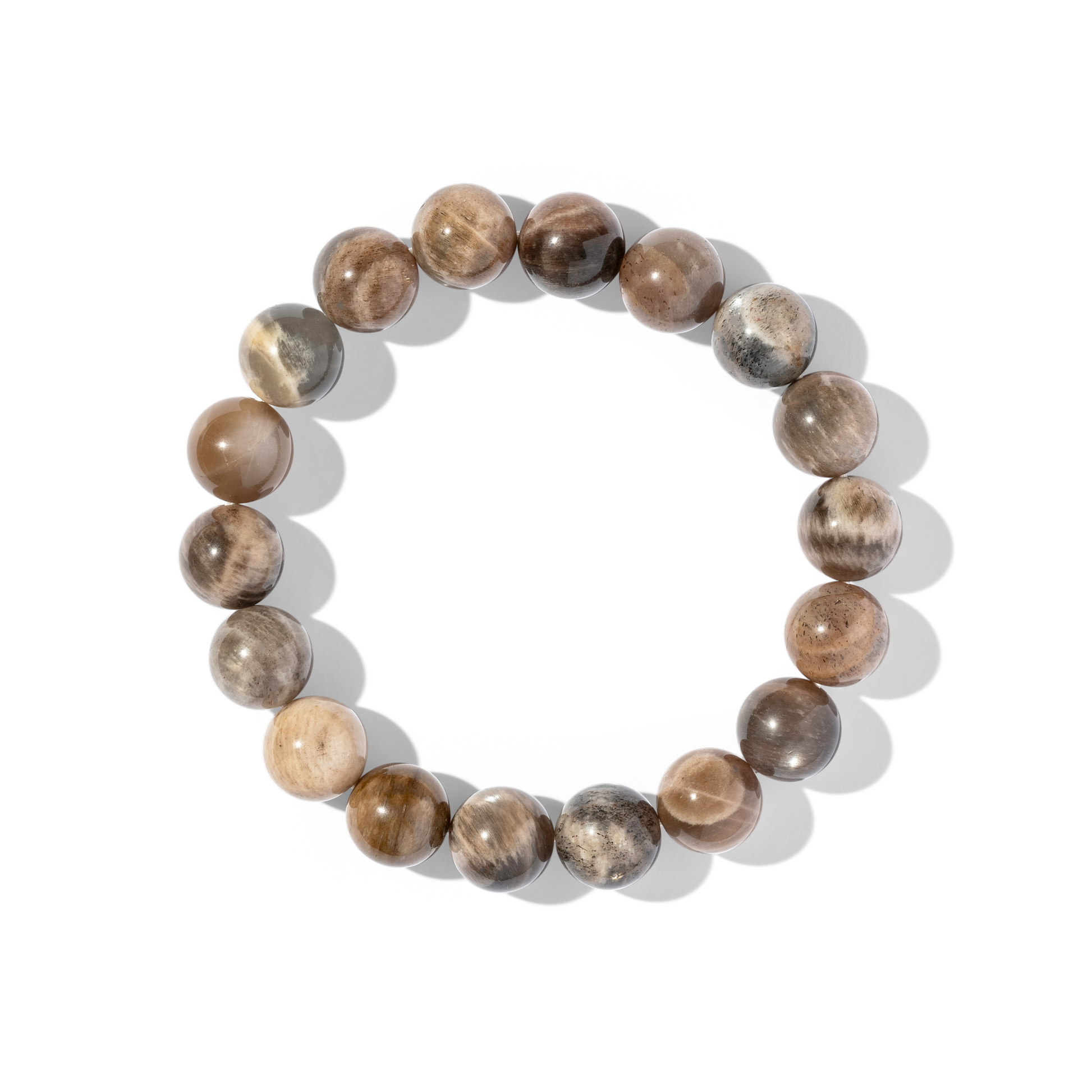 A single crystal gemstone bracelet made of tan moonstone. Tan moonstone is an opaque, iridescent mixture of light, earthy browns and grey.