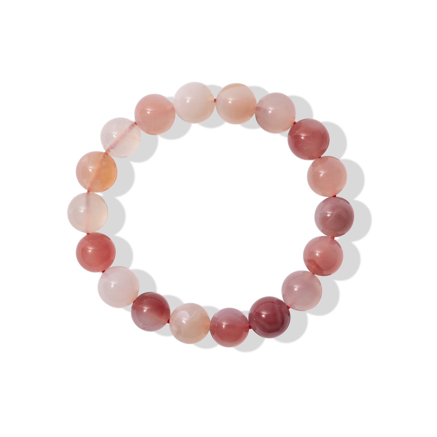 A single crystal gemstone bracelet made of Yanyuan pink agate - a semi opaque, shiny mixture of white and pink shades.